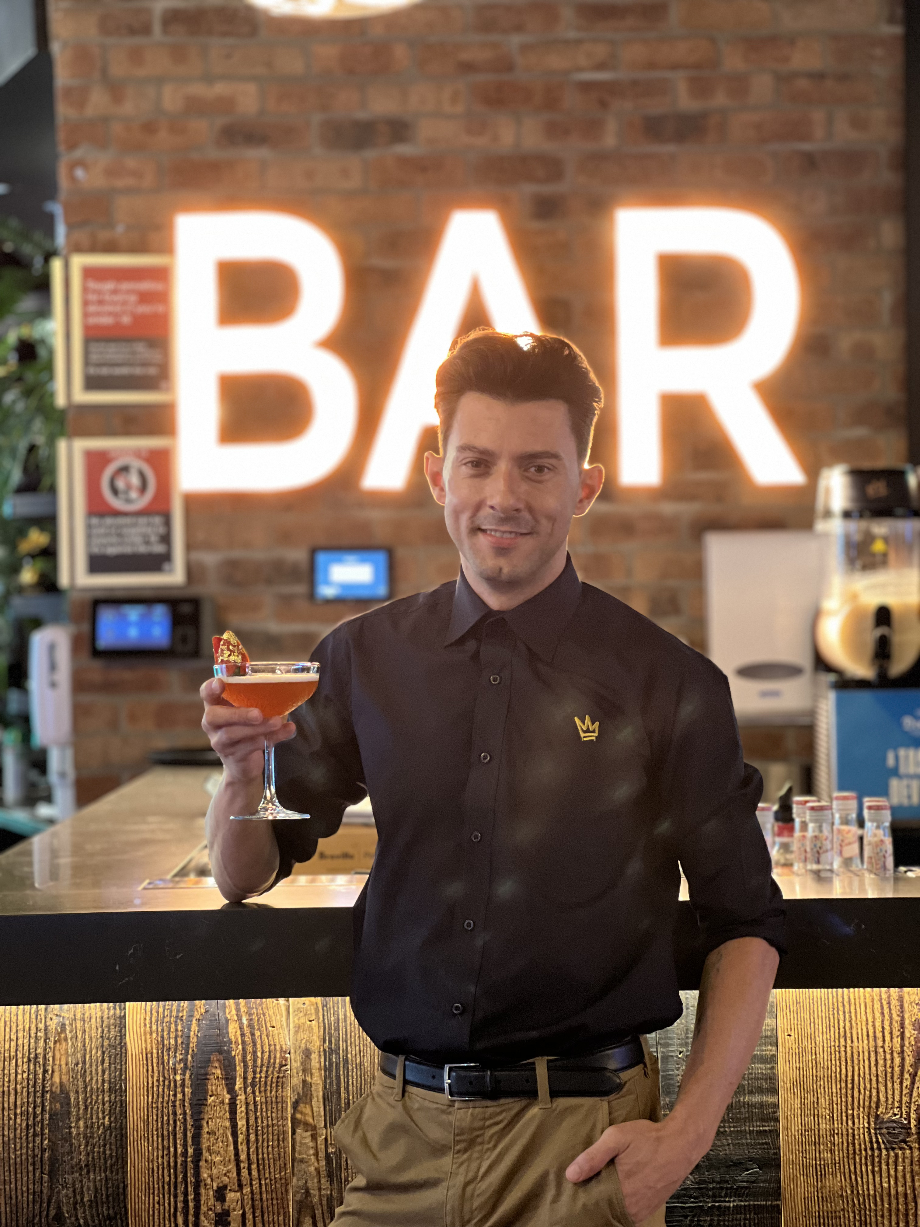 Chris Burke holding the Grand Dame Cocktail - Competition Winner